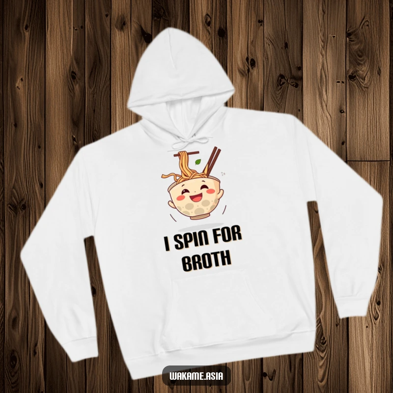 Funny hoodie featuring a grinning anthropomorphic ramen bowl spinning with noodles flying, a cozy and humorous food-themed garment.